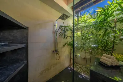 a bathroom with a shower with plants in it at Villa Teman - Luxury 4BR Villa in Central Seminyak - HUGE POOL in Seminyak