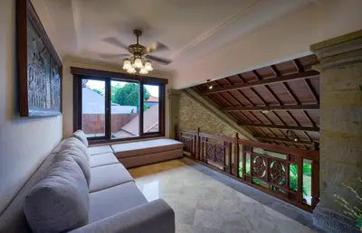 a living room with a couch and a window at Villa Deh Simba at Oberoi in Seminyak