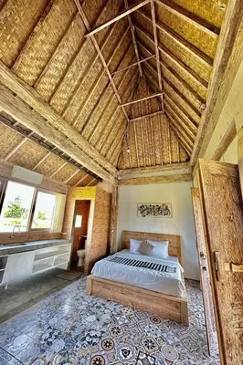 a bedroom with a bed in a room with a wooden ceiling at Bali Eco Living Yoga Healing Meditation and Retreat Center in Denpasar