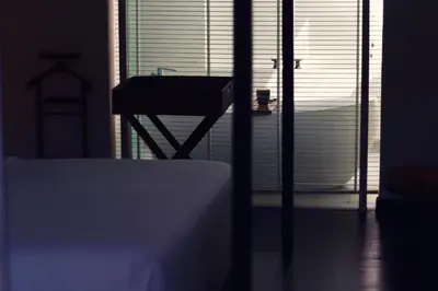 a bedroom with a table and a window with a view at hu'u Villas in Seminyak