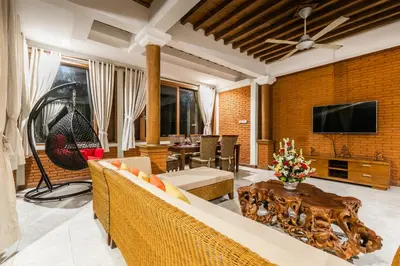 a living room with a couch and a tv at Listien Villa N3 in Seminyak