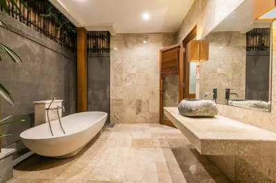 a bathroom with a tub and a sink at Listien Villa N3 in Seminyak