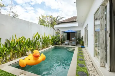 a pool with two inflatable rubber ducks in the water at Villa Cathy, Seminyak - Private 3 Bedroom Pool Villa! in Seminyak