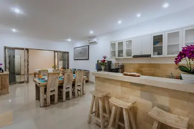 a kitchen and dining room with a table and chairs at Villa Cathy, Seminyak - Private 3 Bedroom Pool Villa! in Seminyak