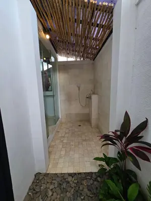 a bathroom with a walk in shower and a toilet at Villa Akasha Luxury 6 bedroom villa near beach in Canggu