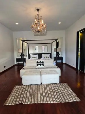 a large bedroom with a large bed and a chandelier at Villa Akasha Luxury 6 bedroom villa near beach in Canggu
