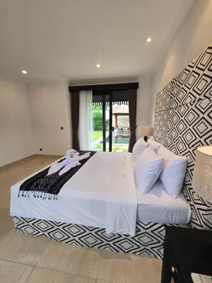 a bedroom with a large bed with white sheets and pillows at Villa Akasha Luxury 6 bedroom villa near beach in Canggu