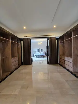 a large room with wooden doors and a large building at Villa Akasha Luxury 6 bedroom villa near beach in Canggu