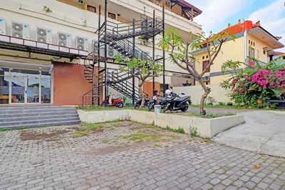 a motorcycle parked in front of a building at Guest House Simalem in Legian