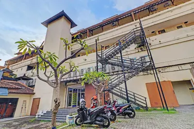 two motorcycles parked in front of a building at Guest House Simalem in Legian