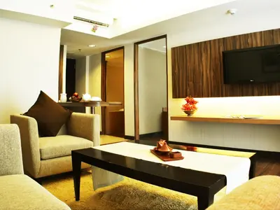 a living room with a couch and a coffee table at Ramada by Wyndham Bali Sunset Road Kuta in Kuta