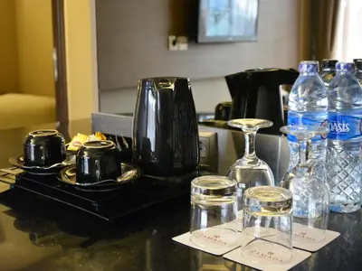a counter top with glasses and bottles of water at Ramada by Wyndham Bali Sunset Road Kuta in Kuta