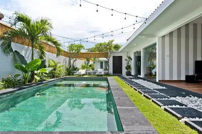 an infinity pool in the backyard of a house at La Fortuna in Seminyak