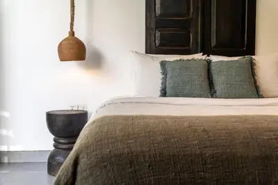 a bedroom with a bed with green pillows at Villa WoW Canggu in Canggu