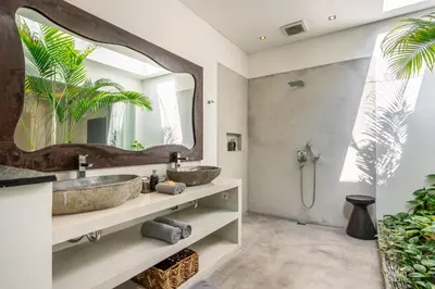 two sinks in a bathroom with a large mirror at Villa WoW Canggu in Canggu