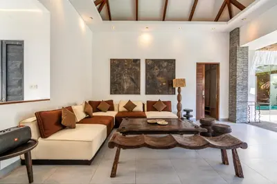 a living room with a couch and a table at Villa WoW Canggu in Canggu