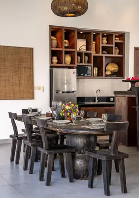 a kitchen with a large wooden table and chairs at Villa WoW Canggu in Canggu