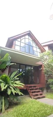 a building with a bunch of windows and some plants at Atra Bambulogy Villa by Bambulogy Resort in Kerobokan