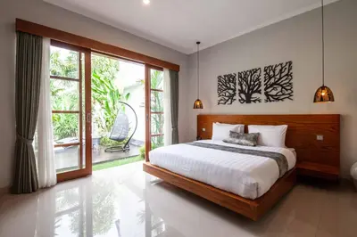 a bedroom with a bed and a large window at Villa Voyage 4 in Seminyak