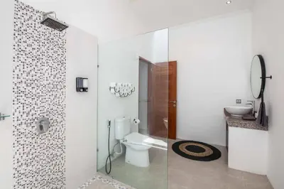 a bathroom with a toilet and a walk in shower at Villa Voyage 5 in Seminyak