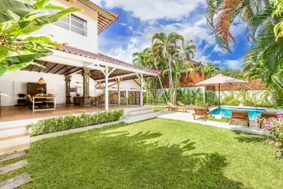 an exterior view of a house with a yard at Villa Berlin - Private 6 BDR Villa in Seminyak with Pool and Garden in Seminyak