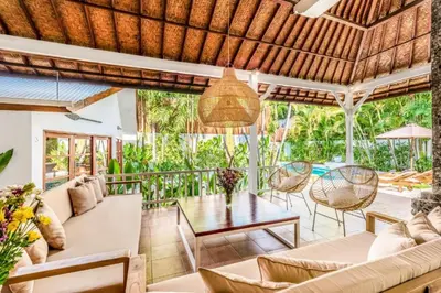 an outdoor living room with a table and chairs at Villa Berlin - Private 6 BDR Villa in Seminyak with Pool and Garden in Seminyak