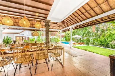 an outdoor dining area with a long table and chairs at Villa Berlin - Private 6 BDR Villa in Seminyak with Pool and Garden in Seminyak
