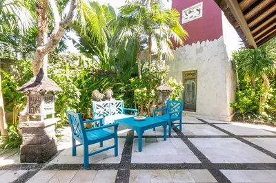 a blue table and chairs on a patio at Villa Angsa by Nakula in Sanur
