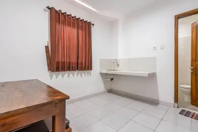 a bathroom with a sink and a toilet at Ganandra Stay Denpasar in Denpasar