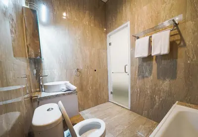 a bathroom with a toilet and a sink at Umaja Villa in Seminyak