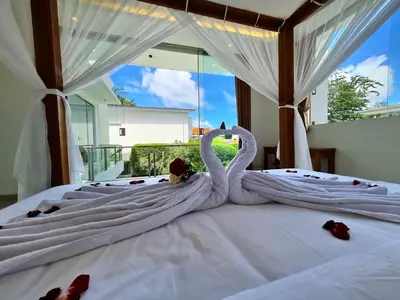 two swans shaped like swans sitting on a bed at Villa Kusamakura Seminyak in Seminyak