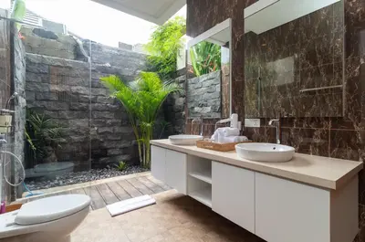 a bathroom with two sinks and a shower at Villa Kusamakura Seminyak in Seminyak
