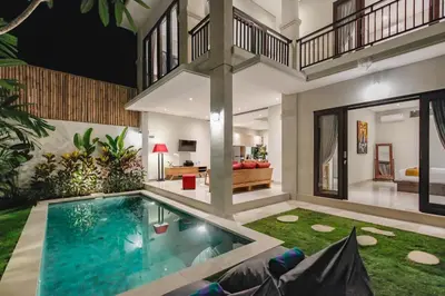 an indoor pool in a house with a living room at Villa 66, 5 min walk to Double 6 beach in Seminyak