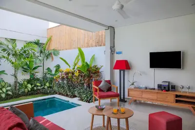 a living room with a tv and a pool at Villa 66, 5 min walk to Double 6 beach in Seminyak