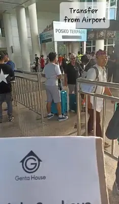 a group of people waiting in line at an airport at Genta House in Kuta
