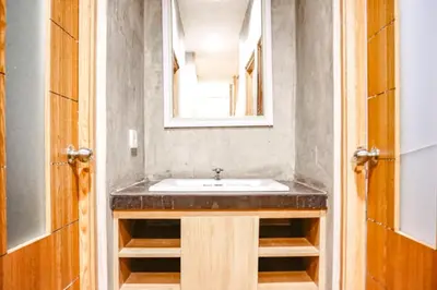 a bathroom with a sink and a mirror at RedDoorz Hostel Near Ngurah Rai Airport Kuta in Kuta