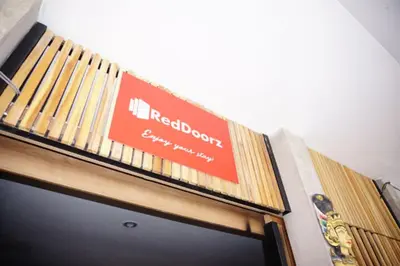 a sign on the top of a building at RedDoorz Hostel Near Ngurah Rai Airport Kuta in Kuta