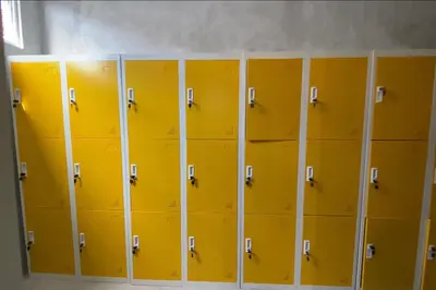 a row of yellow lockers in a locker room at RedDoorz Hostel Near Ngurah Rai Airport Kuta in Kuta