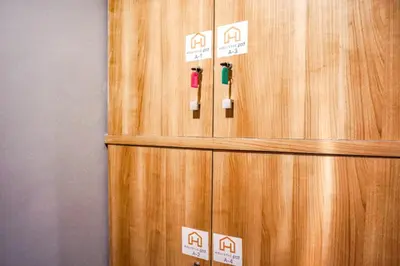 a wooden locker door with cards on it at RedDoorz Hostel Near Ngurah Rai Airport Kuta in Kuta