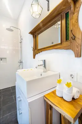 a bathroom with a sink and a mirror at Casa Su Seminyak in Seminyak