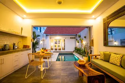 a kitchen and a living room with a swimming pool at Casa Su Seminyak in Seminyak