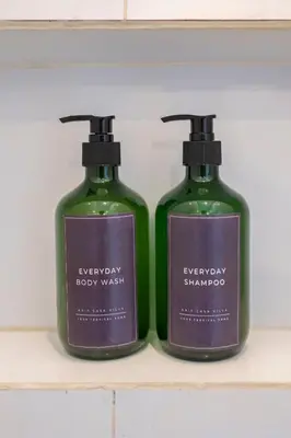 two bottles of soap sitting on a shelf at Casa Nisa Seminyak in Seminyak