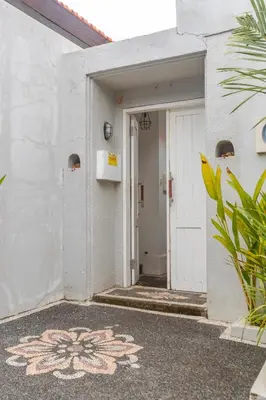 a white door with a flower painted on the side of a building at Casa Nisa Seminyak in Seminyak