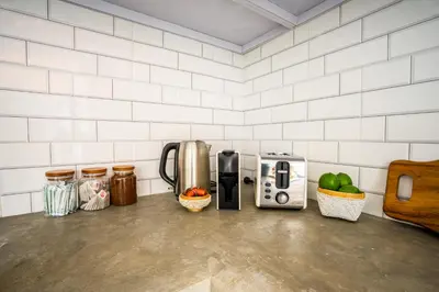 a kitchen counter with a coffee maker and a microwave at Casa Ku Seminyak in Seminyak