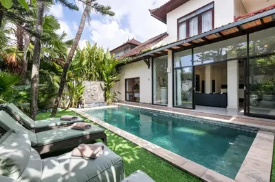 an exterior view of a villa with a swimming pool at Saga Villas Legacy in Seminyak