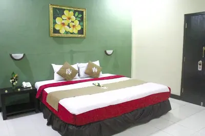 a bedroom with a large bed in a room at Troppo Zone Puri Rama Resort Kuta in Legian