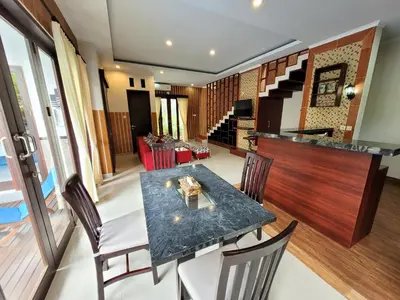a dining room with a table and chairs at Ramantika Sunset Bay in Nusa Dua