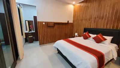 a bedroom with a large bed with red pillows at Ramantika Sunset Bay in Nusa Dua