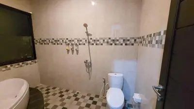 a bathroom with a toilet and a sink at Ramantika Sunset Bay in Nusa Dua