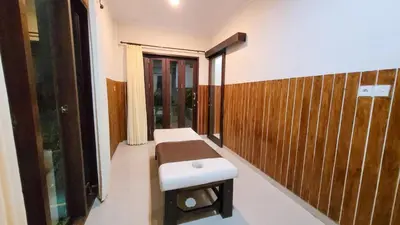 a room with a bench and a window at Ramantika Sunset Bay in Nusa Dua